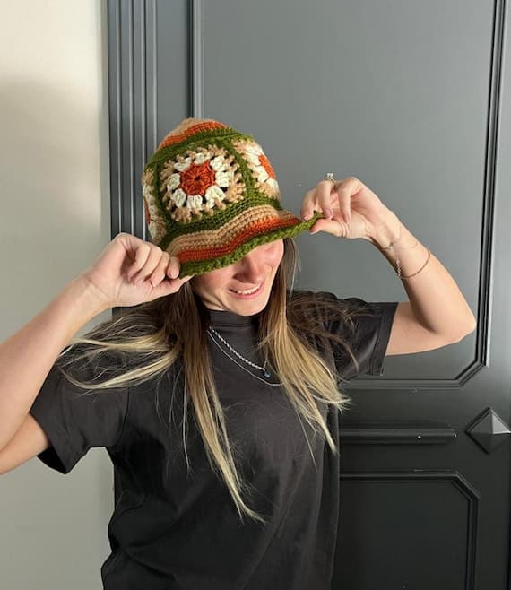 Retro-inspired crochet bucket hat in green, orange, and earthy cotton tones